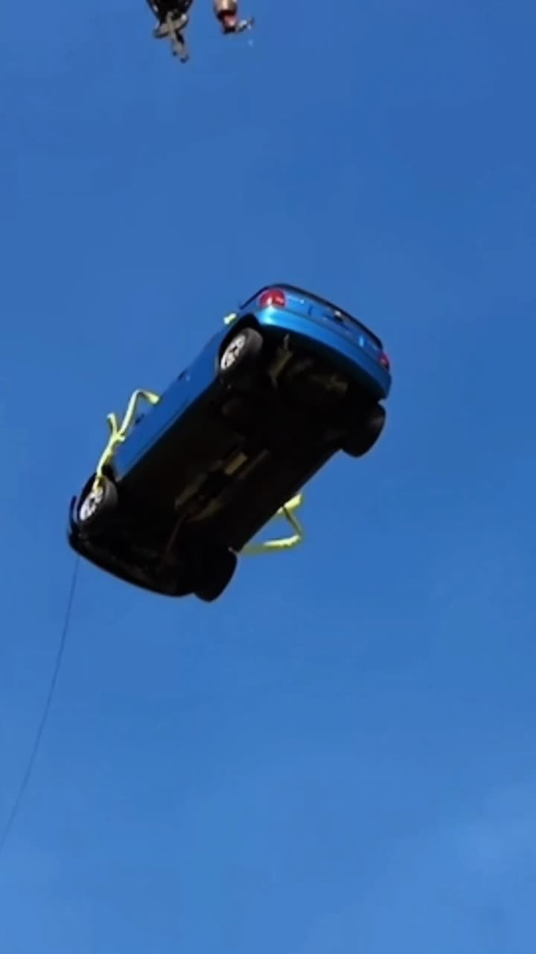 Blue car launched into the air against a clear sky with viral hook text